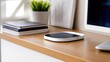© Matthew - Modern workspace featuring a sleek device on a wooden desk with notebooks and a plant