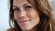 © Mateus - Close-up portrait of a smiling woman with freckles and brown hair. She appears warm, inviting, and naturally beautiful in soft lighting.