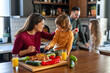 © NDABCREATIVITY - Happy family is cooking together in a bright kitchen, showing joy, teamwork, and love at home