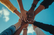 © Sandu - Diverse hands unite under a blue sky, symbolizing collaboration and community spirit in a shared endeavor