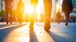 © Koplexs-Stock - Feet walking on a city street with sunlight and blurred figures.