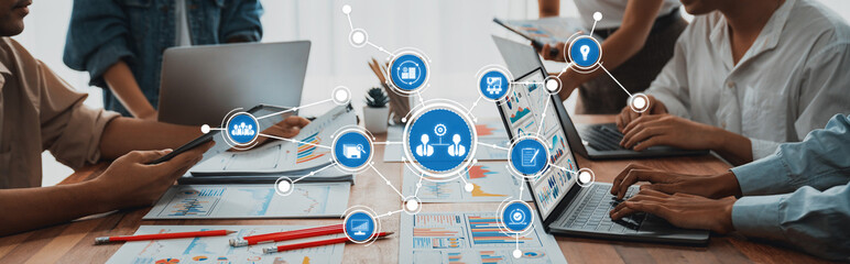 Fototapete - This image captures a vibrant business meeting with team members collaborating over laptops and infographics, showcasing innovation and effective communication in the workspace. Amity