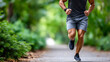 © Alex Alex - A man running along a park path. His torso and legs are in the frame.