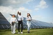 © Serhii - Group of multi ethnic people and safety helmets staring at solar farm.