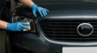 © Vasiliy - Hands in blue gloves cleaning car headlight with sponge applicator. Auto detailing and polishing process of vehicle exterior parts. Professional service concept for car appearance, light efficiency