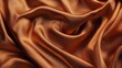 © Honey - A close up view of a luxurious copper colored silk fabric with soft folds and subtle light reflections