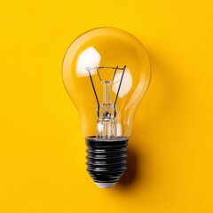 Fototapete - Illuminating Innovation: A Classic Light Bulb on a Vibrant Yellow Background, Symbolizing Ideas and Inspiration