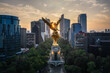 Aerial view of the majestic Angel de la Independencia monument surrounded by skyscrapers at sunset, Cuauhtemoc, Mexico City, Mexico.
