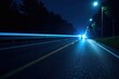 © Prasert - Blue car headlights streak across dark asphalt at night , vehicle, long exposure, street