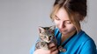 © Chimpanzky  - Heartwarming image of a veterinarian gently holding a cute kitten, showcasing care, compassion, and professional pet care. Perfect for themes related to veterinary services, animal health, pet love