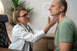 © Nenad - Endocrinologist examining throat of man in clinic. Men with thyroid gland test . Endocrinology, hormones and treatment. Inflammation of the sore throat
