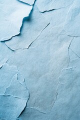 Wall Mural - abstract texture of torn light blue paper with cracks and crevices.