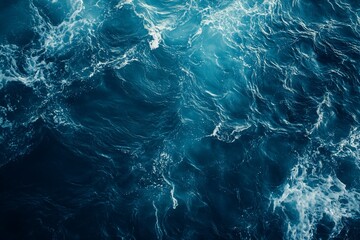 Wall Mural - aerial view of dark blue ocean water with whitecaps and waves.