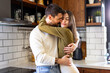 © we.bond.creations - Romantic couple hugging in their modern kitchen, enjoying a quiet moment of affection and togetherness