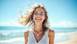 © schiers_images - Cheerful woman with tousled hair enjoying a sunny day at the beach with clear waves in the background, radiating joy and a positive mood under a bright blue sky.