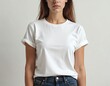 © miss irine - Woman wears white t-shirt mockup front view. Blank t-shirt template on young female, copy space area for design, text or logo placement. Casual wear fashion studio.