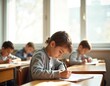 © miss irine - Children writing in classroom. Focused students taking exams. Young students at desks during lessons, learning. Education, growth, child development, cognition. Notebooks, pens, test notes at middle