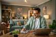 © Miljan Živković - one man adult caucasian work on laptop at home happy smile
