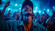 © Katarina - A young man smiling brightly amidst a lively concert crowd, capturing the essence of joy and excitement while immersed in the experience of live music and entertainment.