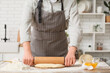 © Pixel-Shot - Woman rolling out fresh dough in kitchen