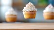 © Arfin - Suspended cupcake with white frosting and sprinkles