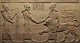 sculpture ancient god Assyrian relief of royal lion hunt, Babylonian and Sumerian old soft blurred art. Remains of civilization of Mesopotamia. Middle East history concept.
