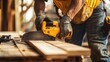 © aubriella - A construction site worker preparing to cut wood with a saw. Featuring precision and focus