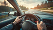 © Muhammad - hands of car driver on steering wheel, road trip, driving on highway road