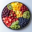 © John - A vibrant rainbow fruit platter featuring watermelon, strawberries, raspberries, grapes, kiwi, pineapple, and mango. Perfect for a summer gathering!