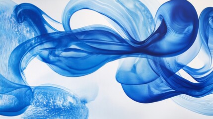 Leinwandbilder - Blue ink dropping into clear water, creating swirling patterns and abstract shapes