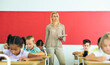 © JackF - Portrait of professional female teacher giving lesson with interested tweens in primary school