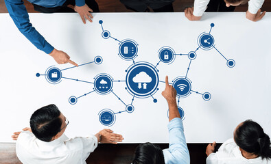 Fototapete - A group of professionals collaborate over a cloud network visualization on a table, illustrating modern computing concepts and innovation in a business environment. Amity
