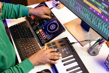 Aufkleber - Sound engineer artist adding effects on his audio files in post production, working with a console and daw software to mix and master tunes. Musician adjusting songs volume levels. Close up.