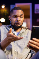 Wall Mural - black guy attending a virtual workshop lecture via online conference, participating at the discussio