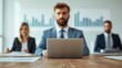 © Lightgeo - A focused meeting scene with professionals discussing data, featuring a man at a laptop and colleagues reviewing documents.