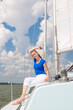 © danmorgan12 - Sea Travel Concepts. One Winsome Happy and Smiling Positive Caucasian Sailor Woman Sitting Relaxing on White Yacht At Daytime on Board.