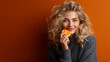 © Alexar_JavaCreator - Beautiful woman eating fruit against colorful background happy expression soft lighting healthy lifestyle photography