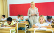 © JackF - Group of focused pupils sitting at classroom working at class with teacher