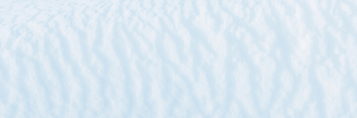 Wall Mural - wide panoramic winter background with snowy ground. natural snow texture. wind sculpted patterns on 
