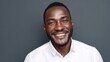 © WS Studio 1985 - Smiling African American Man in White Shirt Against Dark Background