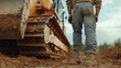 © aubriella - Construction worker guiding a bulldozer to clear land for a new project. Featuring expertise and control