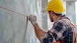 © aubriella - Construction worker marking measurement lines on a wall for installation. Featuring preparation and accuracy