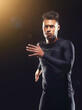 © peopleimages.com - Workout, running and athlete man in studio for sprint exercise, marathon or competition with black background. Sport, lens flare and male model person for speed, endurance training and wellness