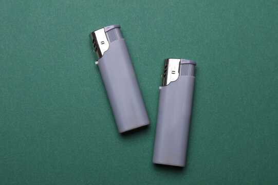 Plastic lighters on a green background