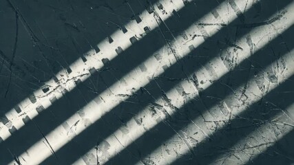 Wall Mural - Dynamic shadows cast by window blinds creating linear patterns on textured wall surface adding contrast and depth