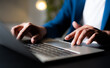 © otello-stpdc - A man using and typing keyboard of laptop computer communicates on internet technology with paperwork on office desk. Workplace, Businessman professional busy working on new job project idea.