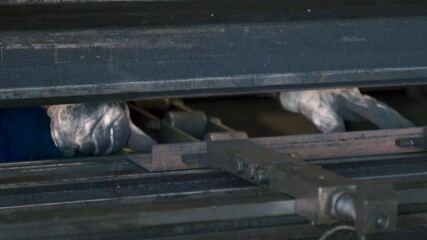 Fototapete - Sheet metal bending process: operator crafts precision parts in workshop
