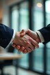 © MarkD - Close-up of two hands clasped in a business handshake within an office , corporate, solidarity