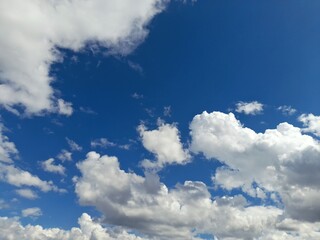 Wall Mural - photo of a clear blue sky covered with clouds