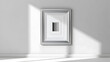 © Gennyson Marinho - A silver framed artwork on a white wall casts dramatic shadows, creating an artistic, modern display.